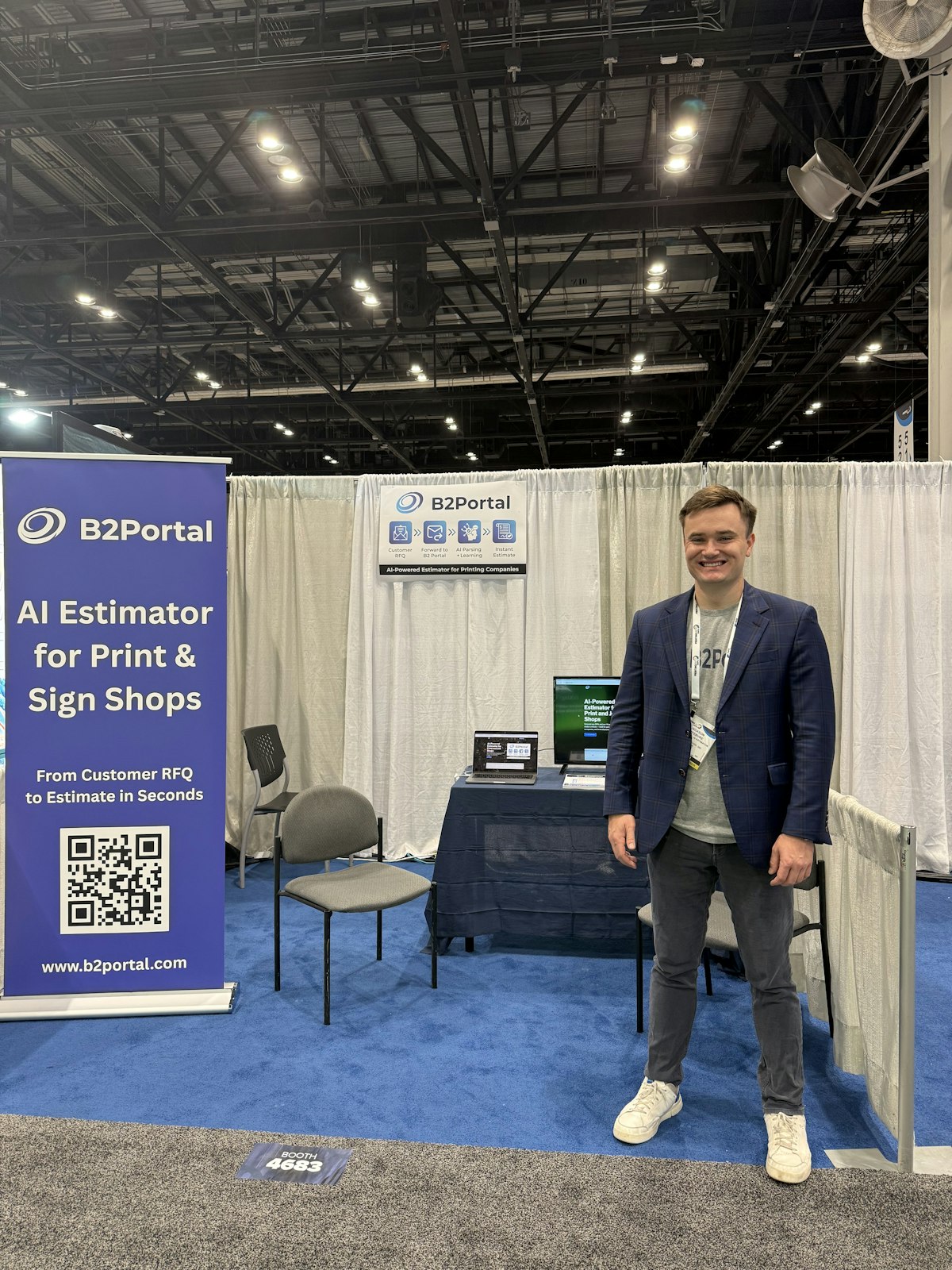 Jackson Lefebvre standing at the B2 Portal booth at the Printing United Expo, showcasing an AI estimator for print and sign shops that automates quotes from customer RFQ emails to MIS systems.