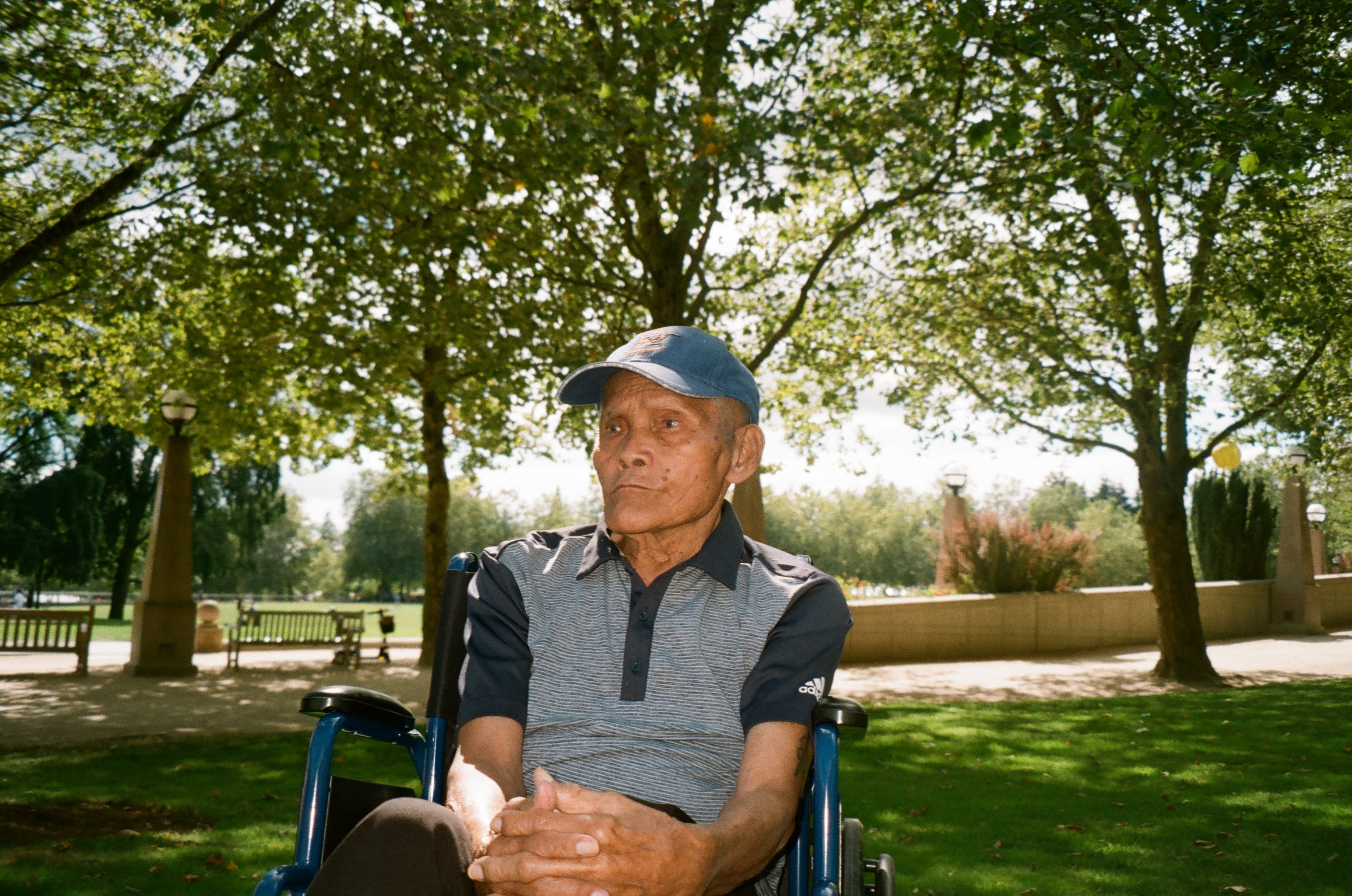Elderly man sitting in United States park.