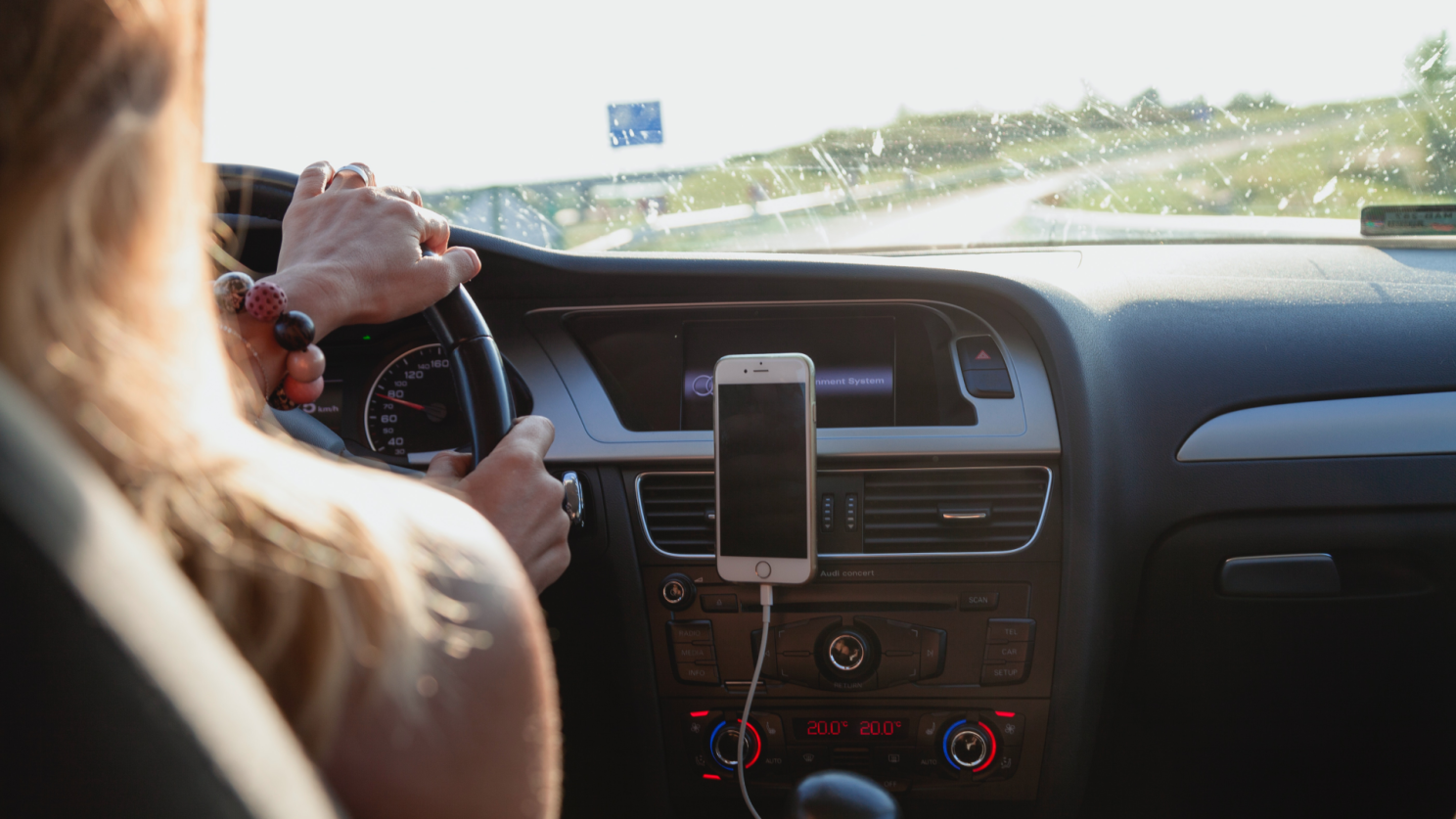 Caregiver commuting to shift in car.