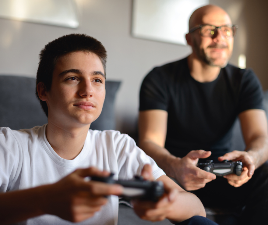 Boy and father playing video games.