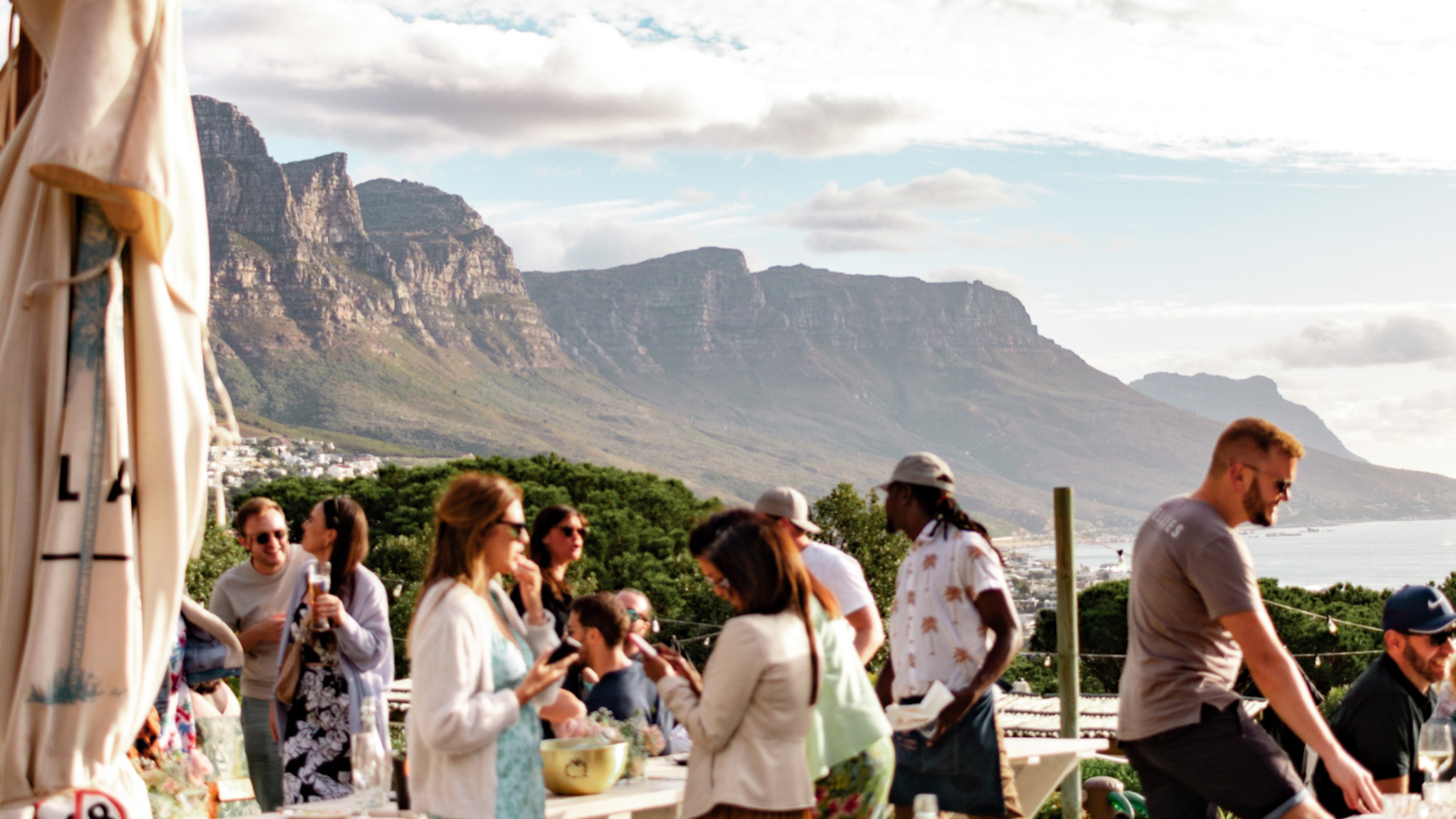 Group of people socializing with Table Mountain in the background, Cape Town.
