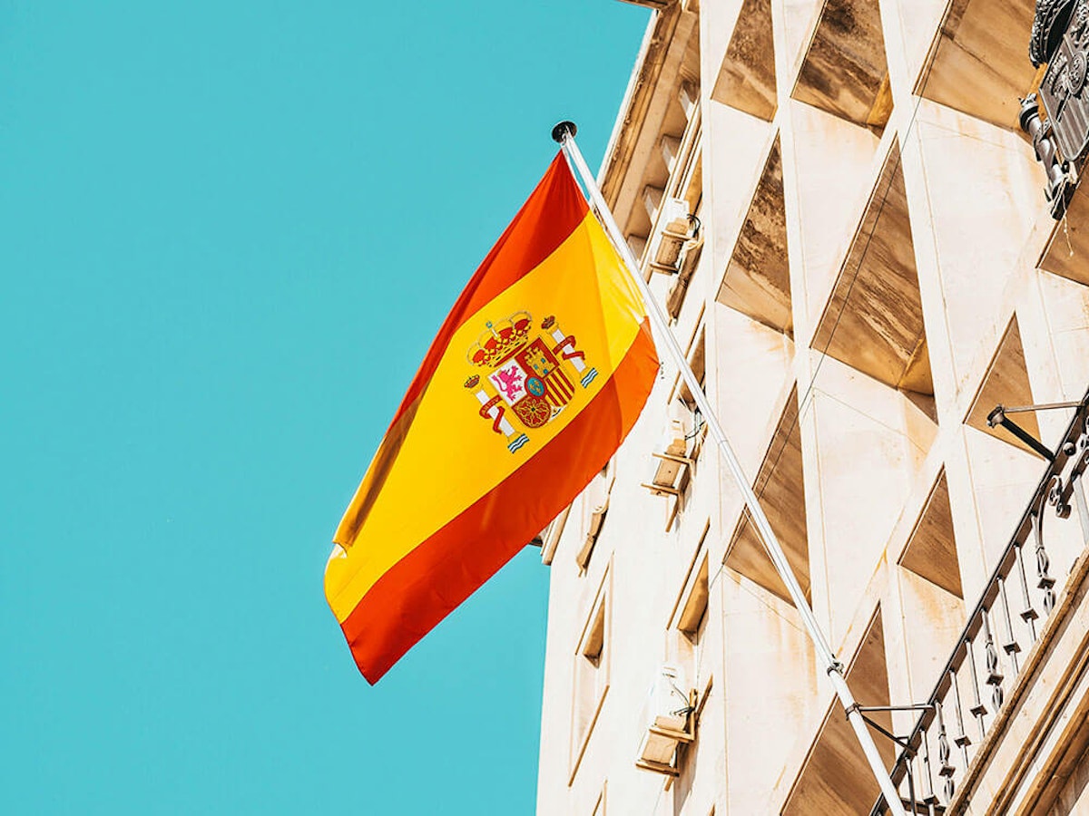 Spanish government building with national flag, representing tax authority for non-resident property owners in Spain