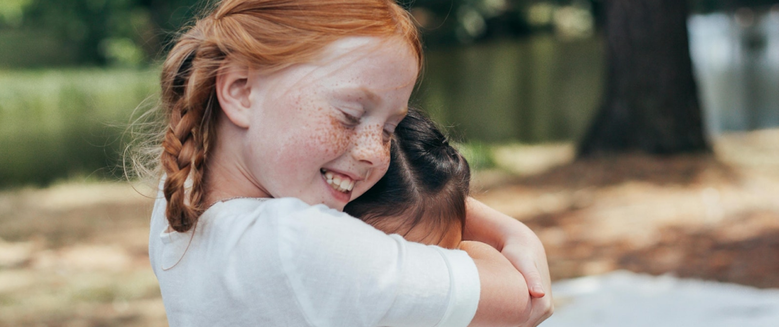 Two small girls hug each other 