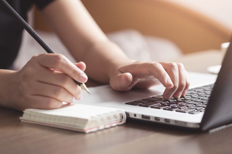 business-woman-working-on-desk-850630688-5b35962f46e0fb00370dc606.jpg