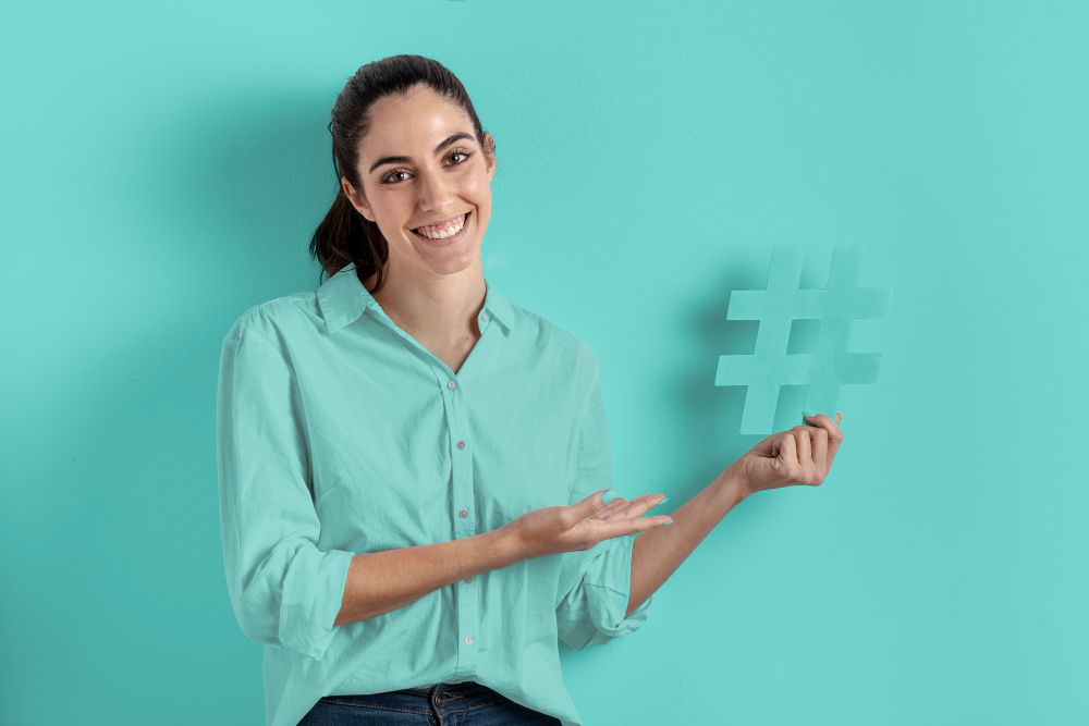 woman holding hashtag sign