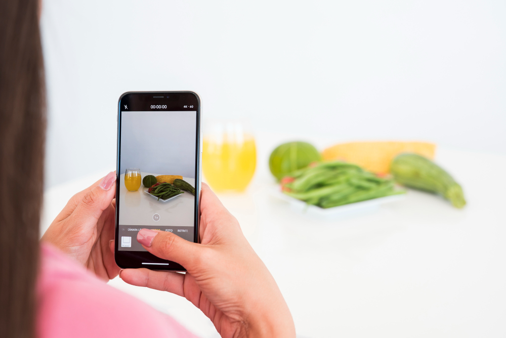  woman taking a picture of vegetables