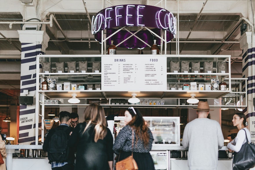 A coffee shop with a large queue of seemingly happy, loyal customers.