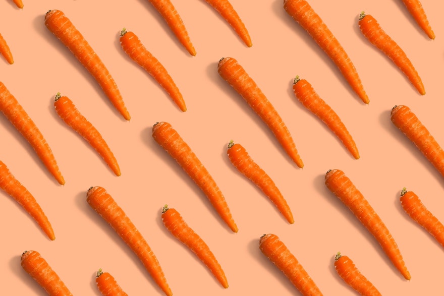 Tiled background image of orange carrots.