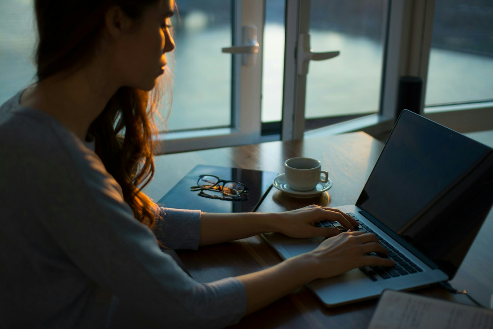 Image of a woman typing on a laptop