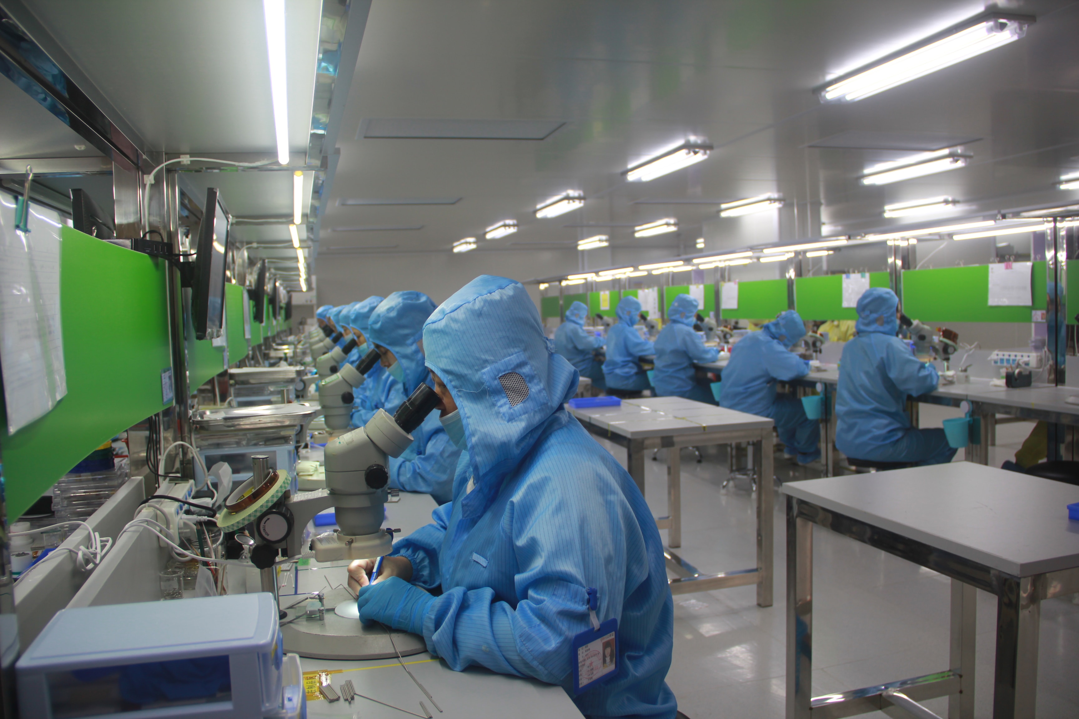 many lab workers in a sterile pharma lab