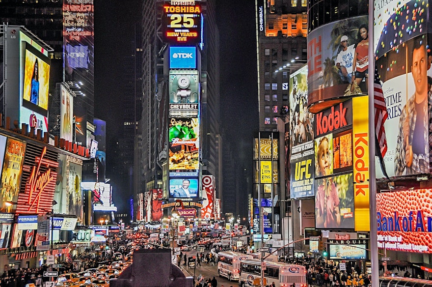 Busy city street with ads showing on billboards