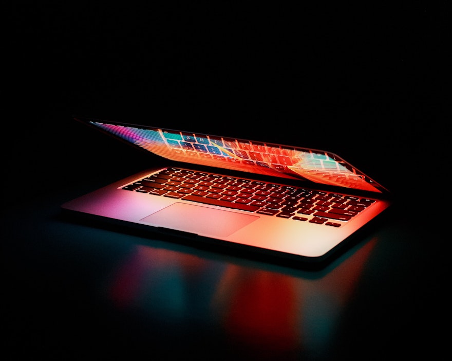 A computer half opened and lit up by