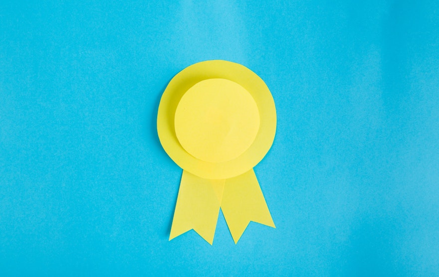 Yellow award ribbon on blue background