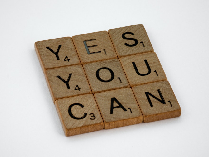 Scrabble tiles spelling "yes you can"