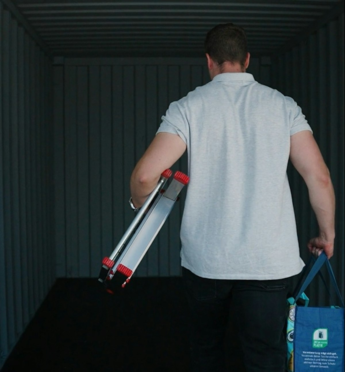 man with ladder in storage container