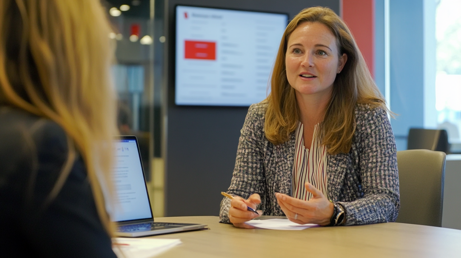 A friendly HR manager engaging in a job interview, highlighting the human touch in AI-assisted hiring processes.
